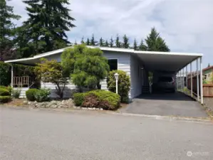 Front of the Home with New Exterior Paint Showing a Full Length Carport.