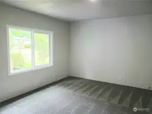 View of the Spacious Primary Master Bedroom with Brand New Carpet, Paint, From the Entry Door.