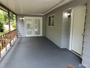 A Different View of the Huge Covered New Painted Front Entry Porch with Double French Door Entry into the Extra Living Area.