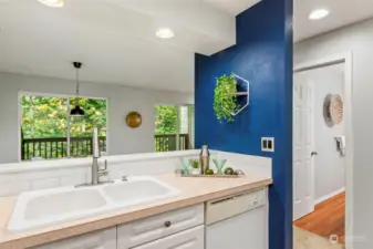 View from kitchen to back deck, & guest bathroom in distance