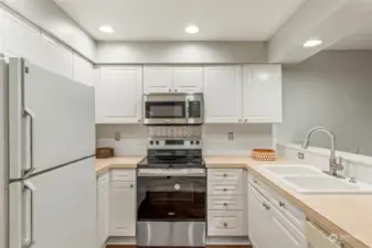 Kitchen w/brand new range/stove. All appliances stay with condo