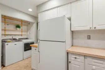 View from kitchen to NEW washer/dryer & hot water tank.