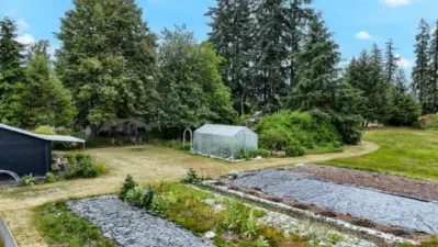 Make your homesteading dreams a reality: tons of garden space plus a greenhouse.