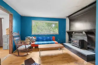 Wonderful wood burning fireplace brings winter warmth and ambiance to the room. Large hearth and mantle above.