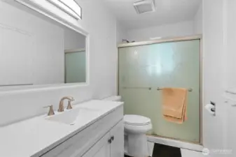 Full guest bathroom with spacious walk-in shower. Matching flooring with the Kitchen.