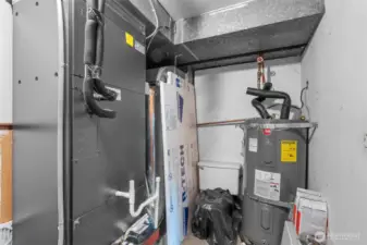 Utility closet on lower level hosts the furnace and water heater.