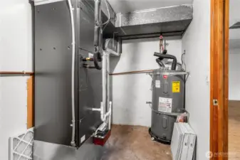Utility closet on lower level hosts the furnace and water heater.