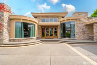 A closer view showcasing this stately home's grandeur with the rounded windows and stone accents.