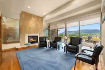The casual living room features a lovely gas fireplace and like most rooms in the house, offers sweeping mountain and golf course views from up here on top of Eagle Nest.