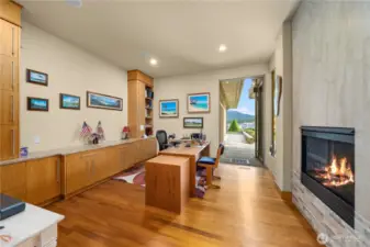 Now this is what a home office should be, offering a relaxing ambiance, an abundance of cabinetry and its own gas fireplace.