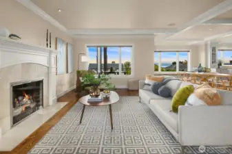 As you step inside to the left of the entry, you're drawn into the inviting living room with gas fireplace and first glimpses of the water and mountain views to come.