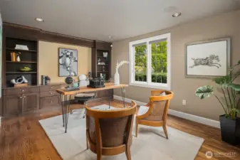 Leaded-windows look out upon the front entry courtyard in the beautiful main floor office.