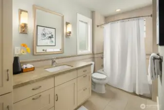 Frosted windows on two sides welcome diffuse natural light into the spacious upper full bath.