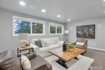 Large windows flood the living room with natural light.