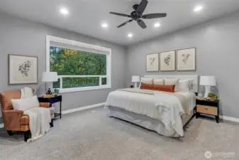 A generous primary bedroom with large picture window pouring natural light into the space.