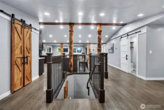 Hardwood floors on main level complemented by rich wood columns and sliding barn doors.