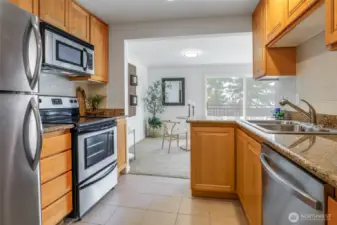 Chef's kitchen with Granite Countertops and Stainless-Steel Appliances.