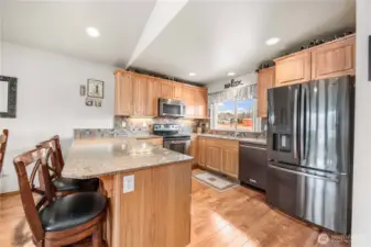 Kitchen bar and stainless steel appliances.