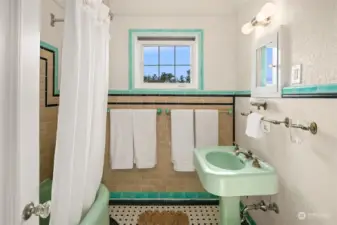Spacious period bath has large tub and original tile.