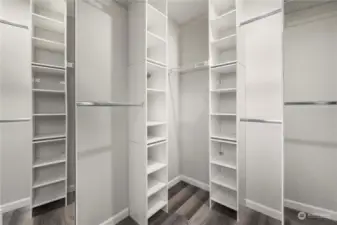 Primary walk-in closet with organizers.