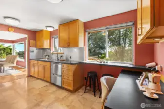 The kitchen connects easily to the dining room and to the outdoor deck. It is the heart of this house!