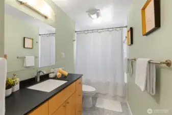 Full bathroom with deep tub for soaking.