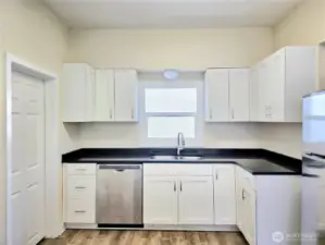 Door to 1/2 bath/laundry & 1 car garage.