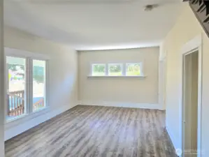 Living room with lots of windows adding natural light.