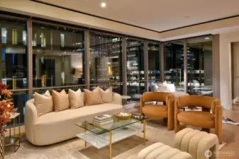 Twilight photo of living room in Unit 1205 with dramatic city light views