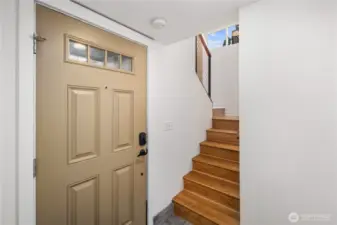 Ground level entry with hardwood stairs to upper floors