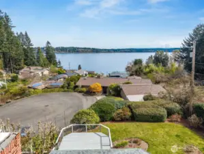 You can see how it all comes together, the deck overlooking the yard, the quiet cul-de-sac, and the water stretching out beyond with Mount Rainier in the distance. It’s a peaceful, tucked-away setting that feels intentional. And then there’s the part that makes daily life easier. This neighborhood runs on a community water system through Thurston County and a shared sewer system maintained by the HOA, so no individual well or septic to manage. The $237/month dues cover more than you might expect, private dock and beach access, road maintenance, insurance, common areas, plus your water and sewer. When you look at it that way, it’s less about dues and more about bundled convenience with some pretty great perks.