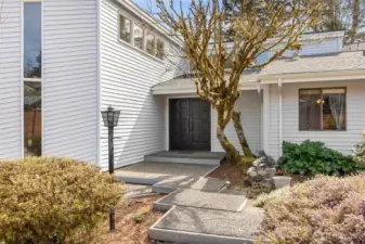 Up close, the craftsmanship really shines. The solid wood double doors have that rich, paneled texture that feels substantial the moment you see it, and those scrolled handles add just the right amount of detail without feeling overdone. It’s a statement entry, but in a grounded, classic way that fits perfectly with the character of Beverly Beach. You can tell this is part of a neighborhood where homes have been cared for and preserved, not rushed or replaced. It sets the tone before you even step inside.