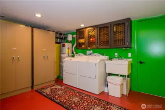 Laundry room with lots of storage and finished storage room with separate door to outside.