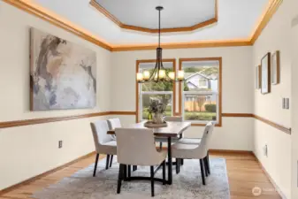 Formal dining room w/ coved ceilings and crown moulding w/ lighting
