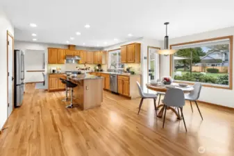 Spacious gourmet kitchen features granite countertop, stainless steel appliances, a wet bar, walk-in pantry and loads of storage