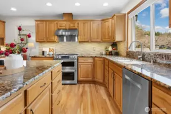 The gourmet kitchen overlooks the beautifully landscaped backyard