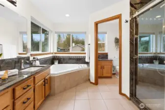 Recently remodeled primary bathroom featuring a frameless shower and new countertops