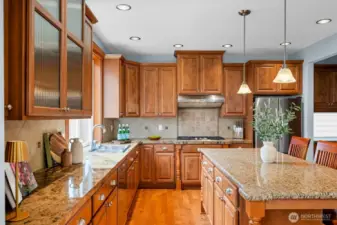 Well-appointed kitchen features abundant cabinetry for ample storage and an oversized island perfect for gathering, prep, and entertaining.