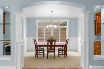 The elegant formal dining room showcases classic wainscoting and refined millwork, complemented by a stylish wine bar—perfect for hosting intimate dinners and sophisticated gatherings.