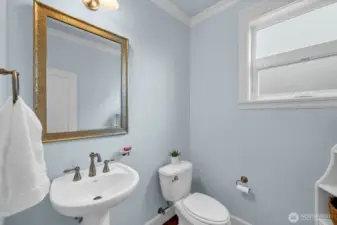 Main level powder room with crown molding.