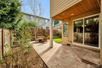 Just outside the patio door is a stamped concrete patio and backyard garden with mature plantings and trees.  Backyard is fully fenced and has plenty of room for alfresco dining!