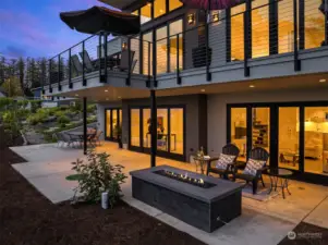 The home boasts custom outdoor stairs and a fireplace with a linear fire feature. What is not to love?