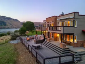 Exterior twilight view 1 of home w/ decks and outdoor living areas.