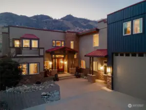 Exterior twilight view 6 of entryway and home overlooking the Columbia River w/ attached garage w/ oversized doors.