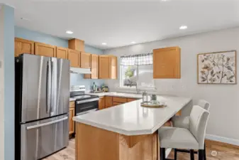 Kitchen providing Corian countertops & peninsula style meal bar or extra food prep serving space.