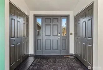 Entryway with two large coat closets.