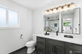 Primary bathroom with quartz countertops and tile flooring