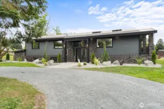 Front exterior with circle driveway.
