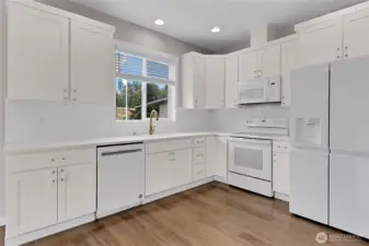 The kitchen boasts lots of cabinets and counter space