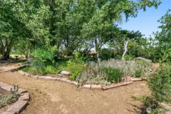 The yard is beautifully landscaped like a park